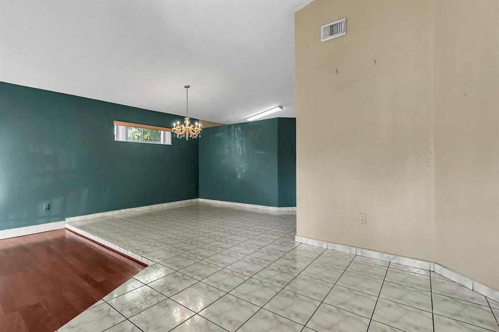3201 West 76th Street Hialeah, FL 33018 - Photo 6 of 43 a view of an empty room with window and wooden floor