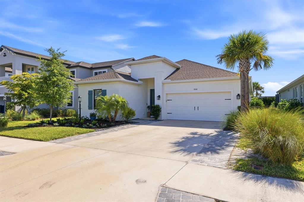 9268 Tequila Sunrise Drive Sarasota, FL 34241 - Photo 3 of 56 a front view of a house with a yard and garage