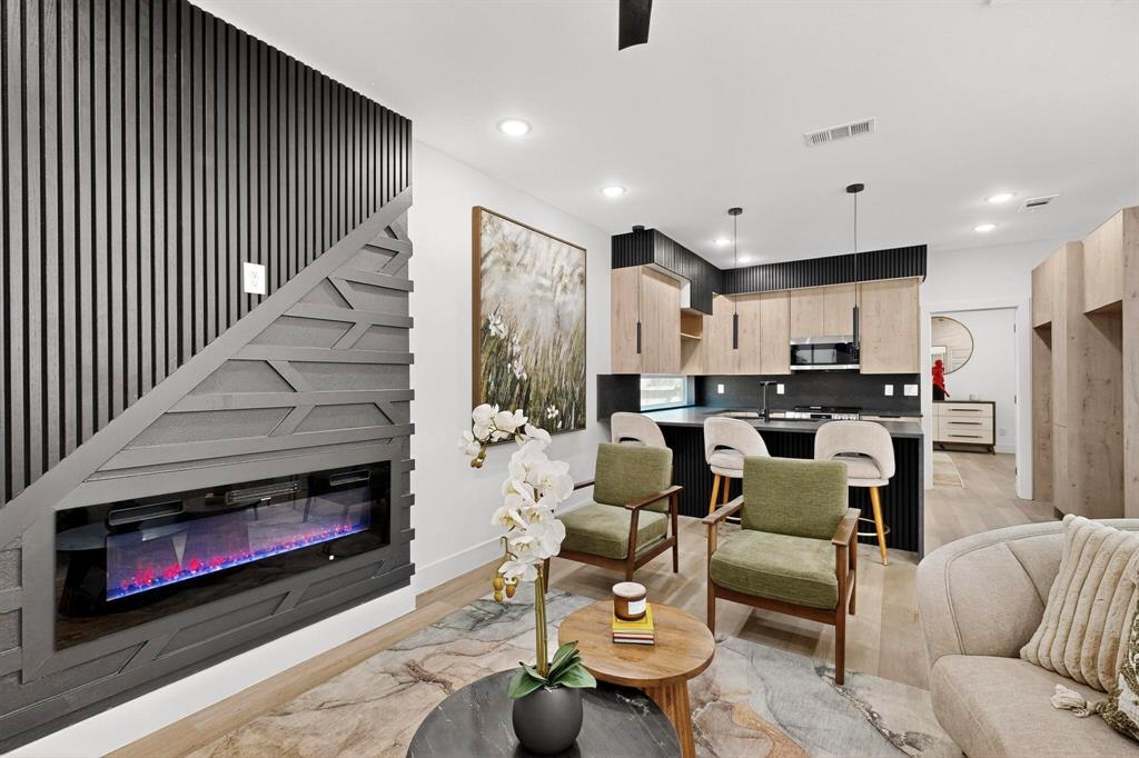 a living room with furniture kitchen view and a fireplace