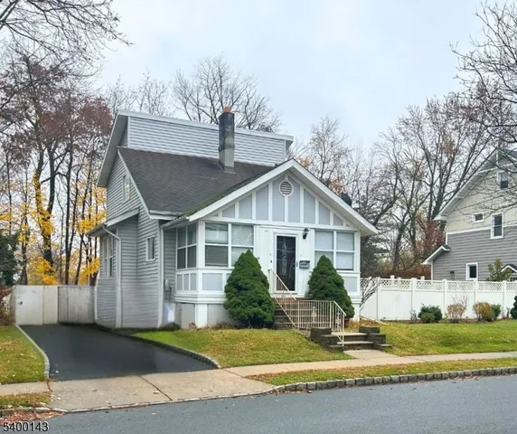 a view of a house with a yard and palm trees