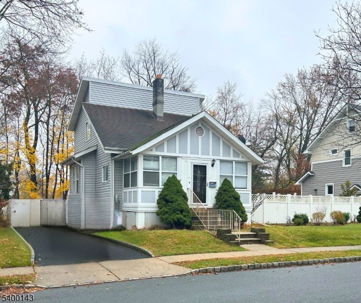 a view of a house with a yard and palm trees
