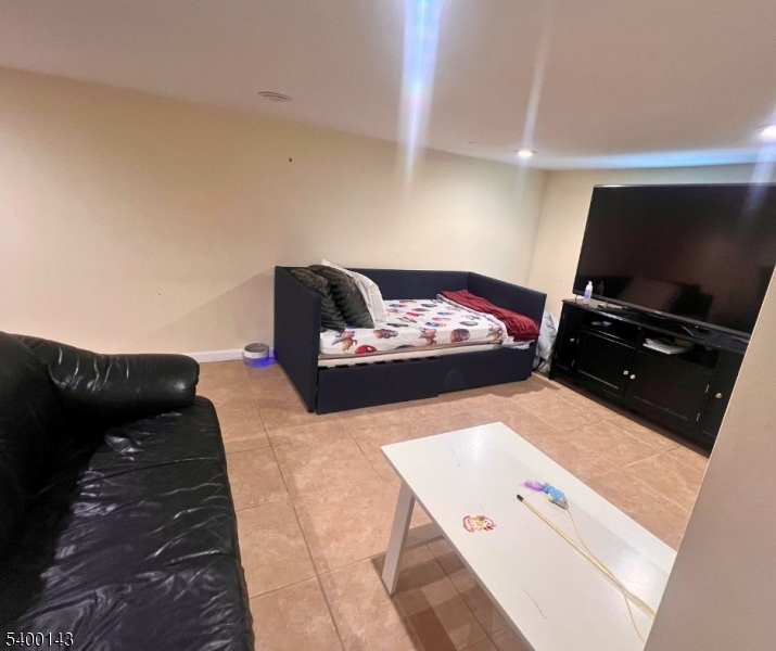 31 Washington Avenue Springfield, NJ 07081 - Photo 17 of 21 a living room with furniture and a flat screen tv