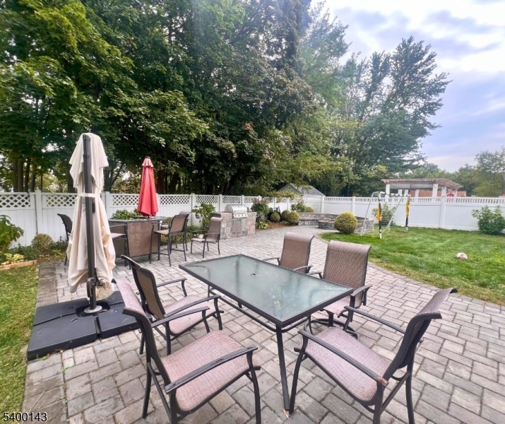 31 Washington Avenue Springfield, NJ 07081 - Photo 19 of 21 a patio with a table and chairs and potted plants