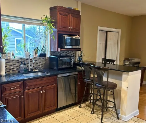 a kitchen with a sink and a stove top oven