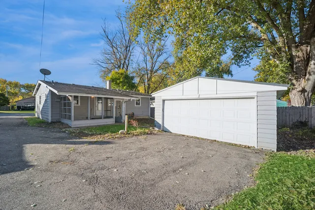 a view of a house with a yard and garage