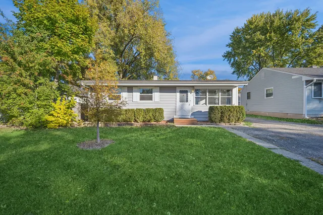a front view of house with yard and green space