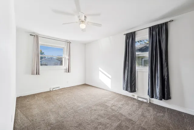 an empty room with windows and closet