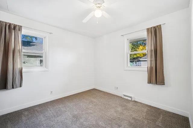 an empty room with windows and entrance