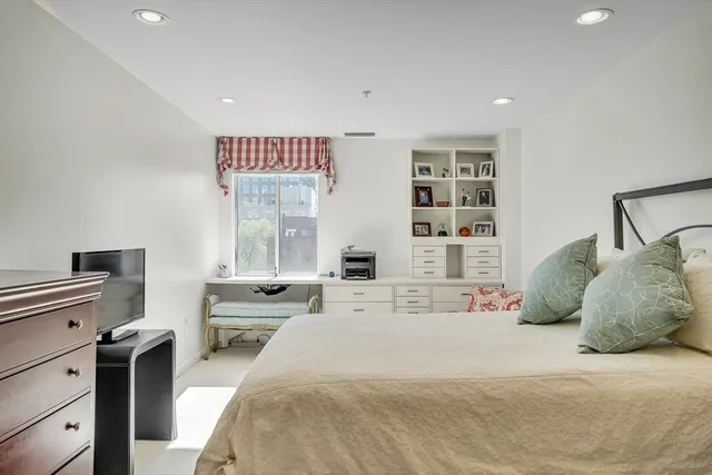 a bedroom with a large bed and a large window