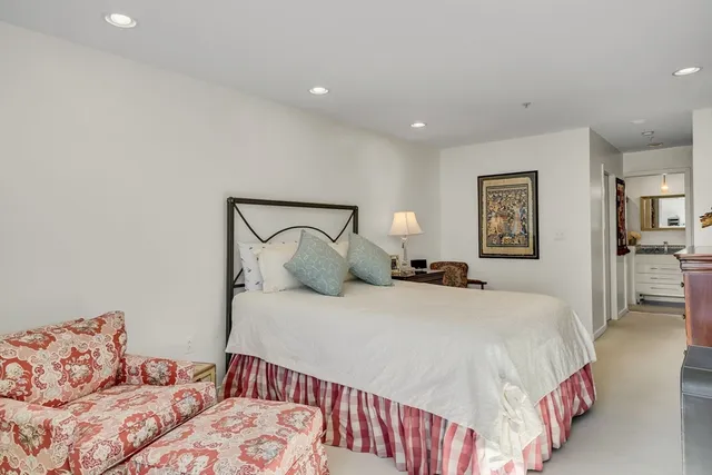 a bedroom with a large bed and a lamp