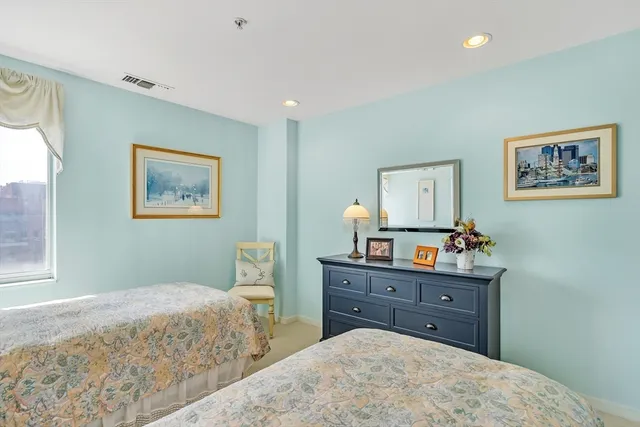 a bedroom with a bed and a dresser