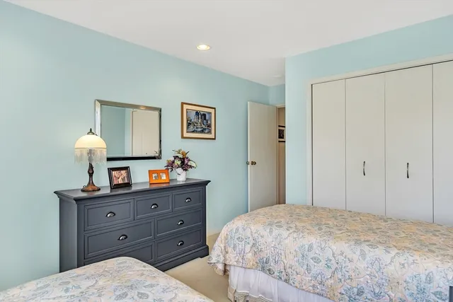 a bedroom with a bed and a dresser in it