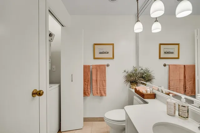 a white toilet sitting next to a bathroom sink and tub