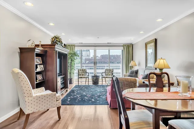 a living room with furniture a flat screen tv and a large window