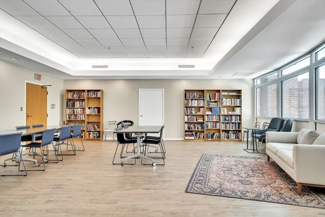 a hallway with white walls and flat screen tv