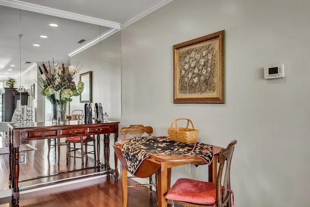 a dining room with furniture and wooden floor
