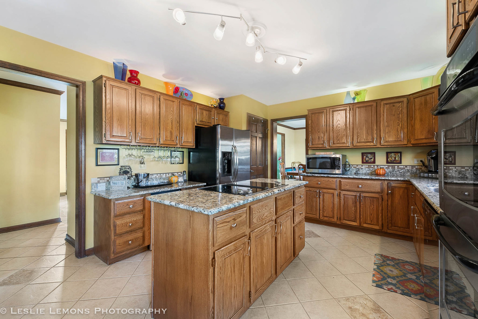 217 West Bailey Road Naperville, IL 60565 - Photo 3 of 24 a kitchen with stainless steel appliances granite countertop a sink and cabinets