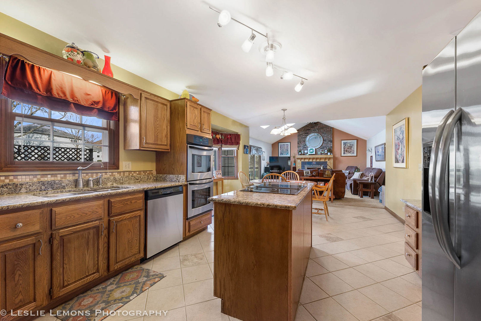 217 West Bailey Road Naperville, IL 60565 - Photo 4 of 24 a kitchen with stainless steel appliances granite countertop a sink and a refrigerator