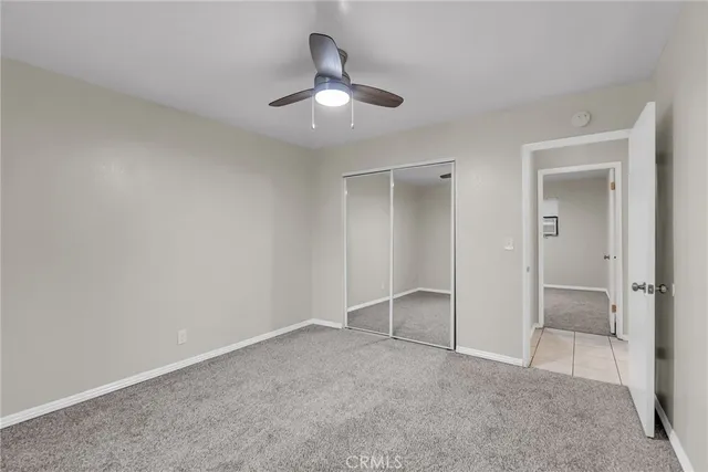 a bathroom with a granite countertop sink toilet mirror and bathtub