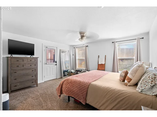 a bedroom with a bed and a flat screen tv