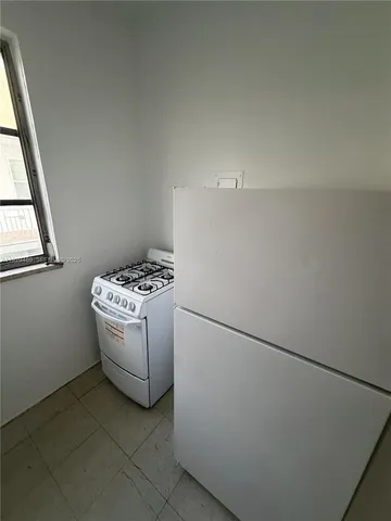 a room with a bed and a stove top oven