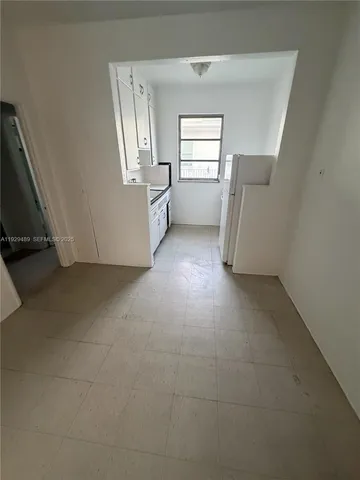 a view of empty room with window and fireplace