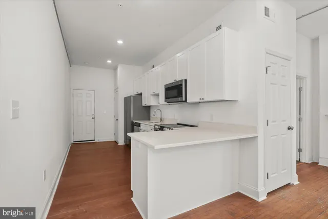 a kitchen with stainless steel appliances a sink stove and refrigerator