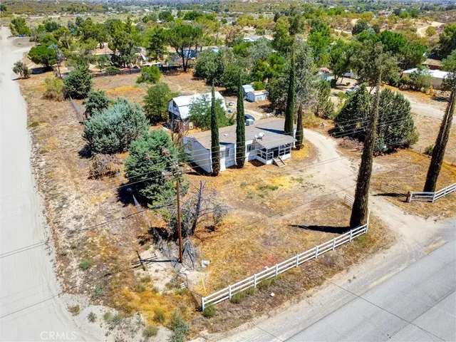 an aerial view of a house with a yard and garden