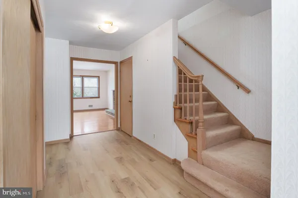 a view of entryway and hall with wooden floor