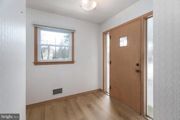 an empty room with windows and closet