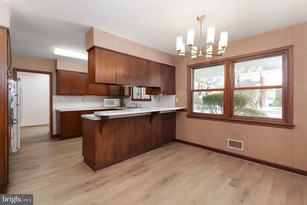 a kitchen with kitchen island granite countertop a sink cabinets and stainless steel appliances
