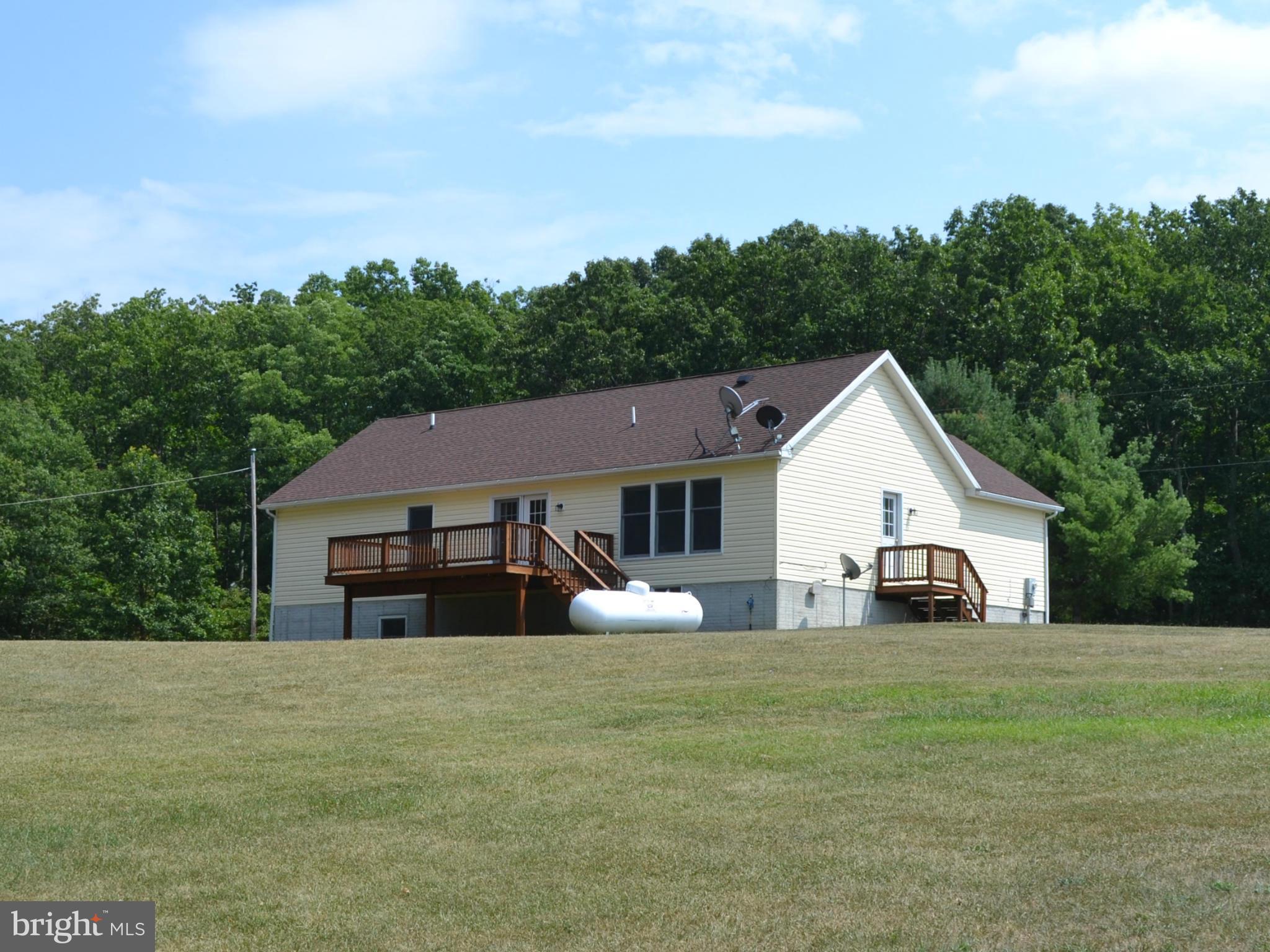381 Reynolds Road Cross Junction, VA 22625 - Photo 23 of 28 a front view of house with yard and trees in the background