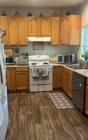 a kitchen with a stove a sink and a microwave