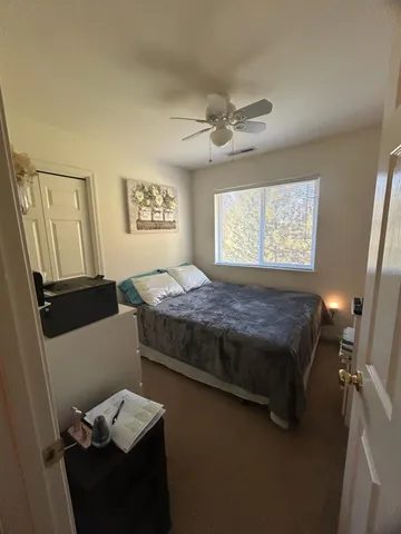 a bedroom with a bed and a window