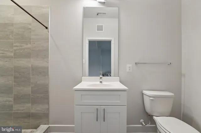 a kitchen with a refrigerator a sink dishwasher and a stove with wooden floor
