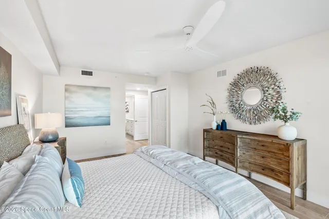 a spacious bathroom with a granite countertop sink a toilet a mirror and shower