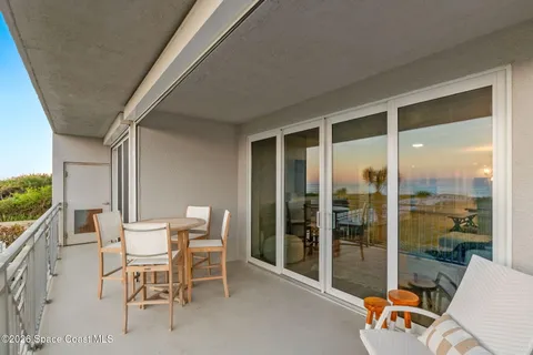 a view of a chair and tables in the backyard