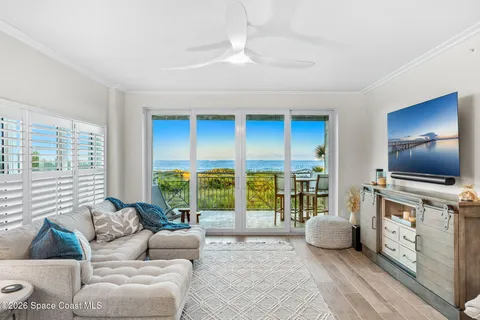 a living room with furniture and large windows