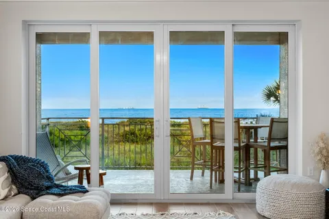a large white kitchen with a large window