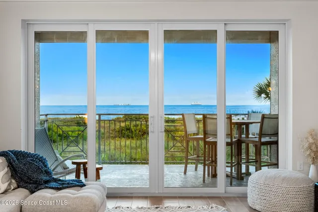 a large white kitchen with a large window