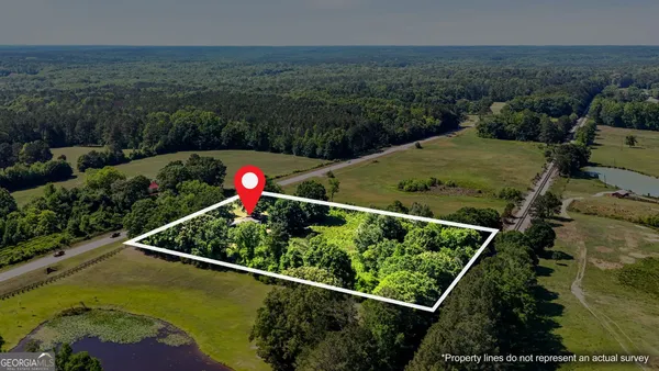 an aerial view of a houses with a yard