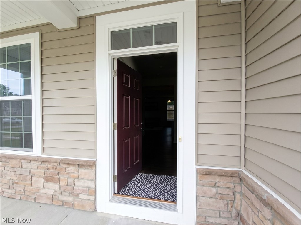 4509 Millbrook Way Akron, OH 44321 - Photo 2 of 27 Entryway featuring a dark paneled door with transom window, framed by broad white trim
