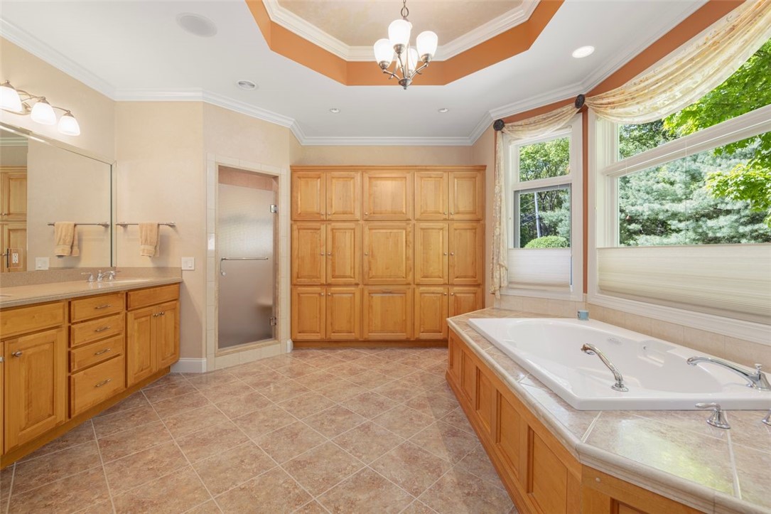 2271 Middle Road East Greenwich, RI 02818 - Photo 24 of 50 Spacious primary bathroom with heated flooring, an abundance of cabinetry, a whirlpool tub and a shower