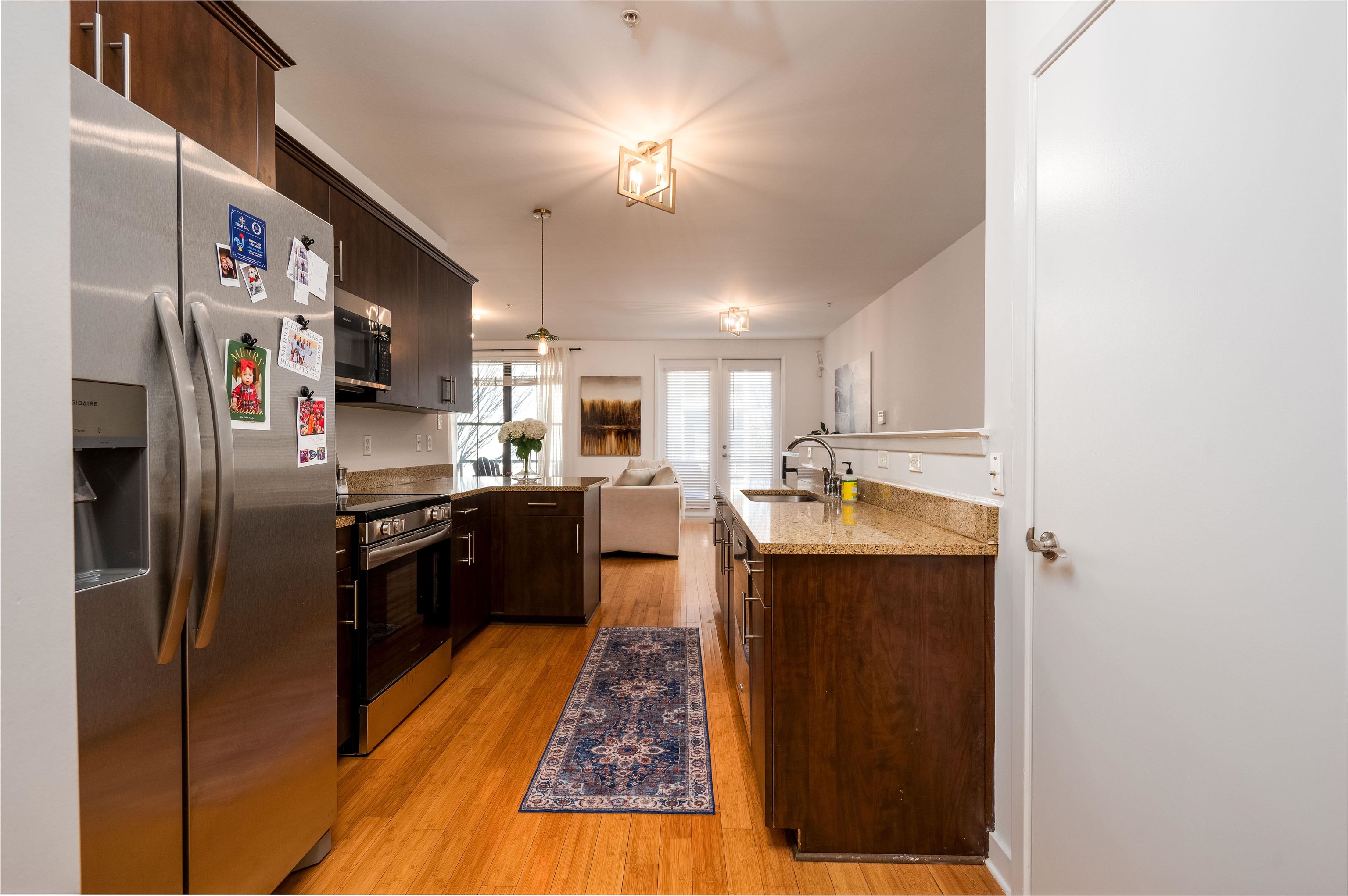 379 Cobalt Bay Loop, Unit 102 Memphis, TN 38103 - Photo 12 of 21 a large kitchen with stainless steel appliances granite countertop a refrigerator and a sink