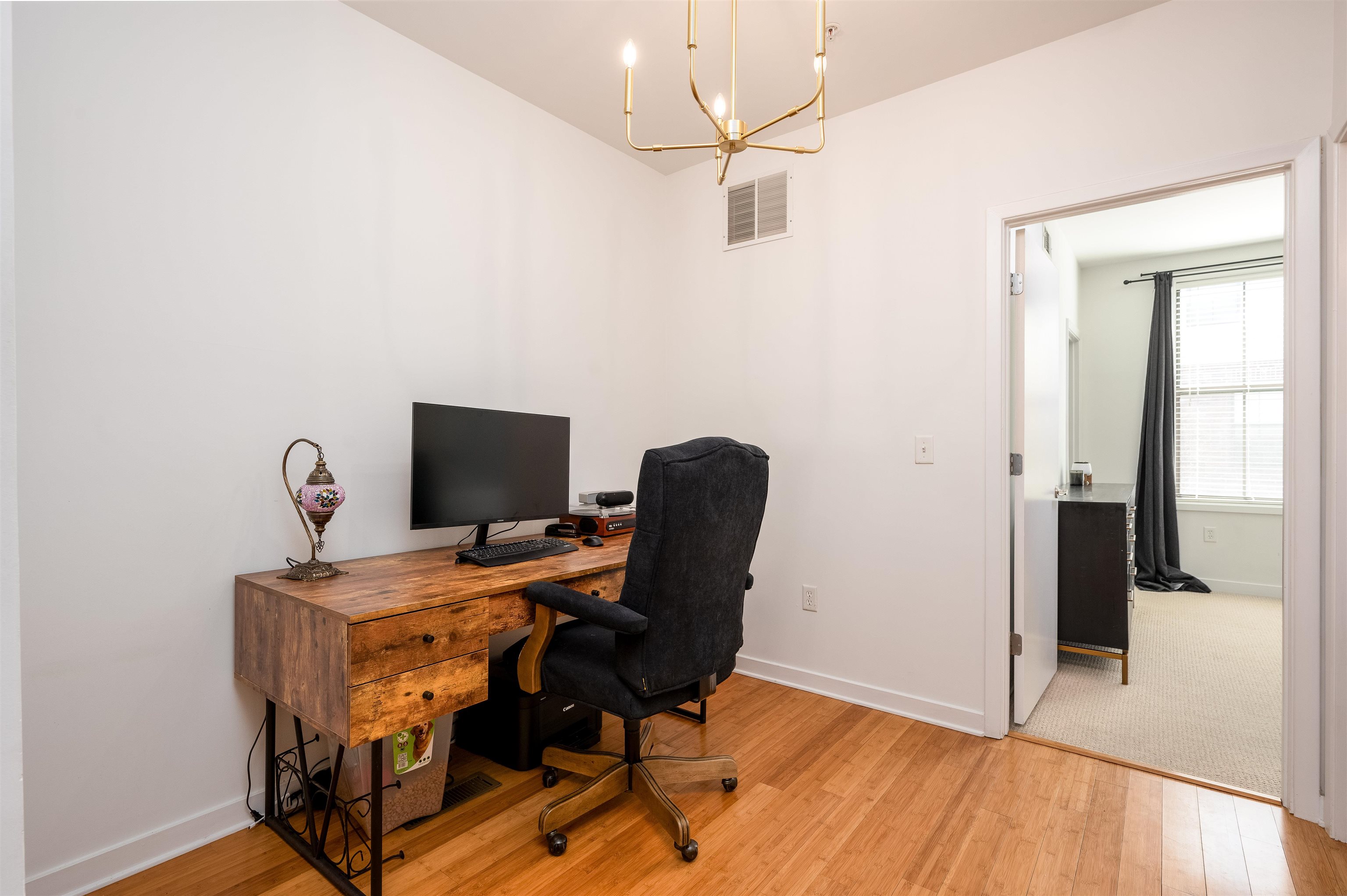 379 Cobalt Bay Loop, Unit 102 Memphis, TN 38103 - Photo 13 of 21 a view of a workspace with furniture and wooden floor
