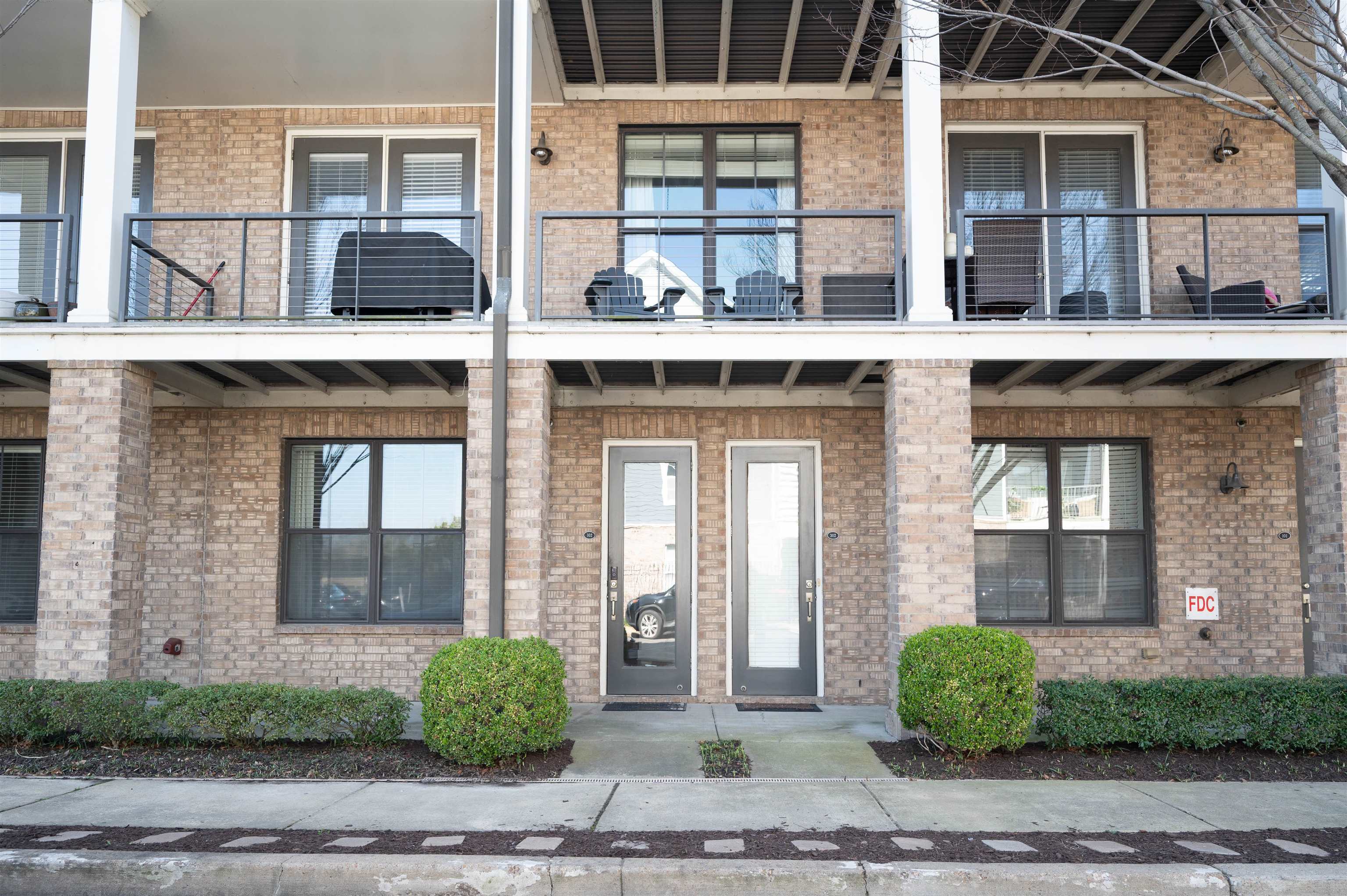 379 Cobalt Bay Loop, Unit 102 Memphis, TN 38103 - Photo 21 of 21 a view of a brick building with large windows