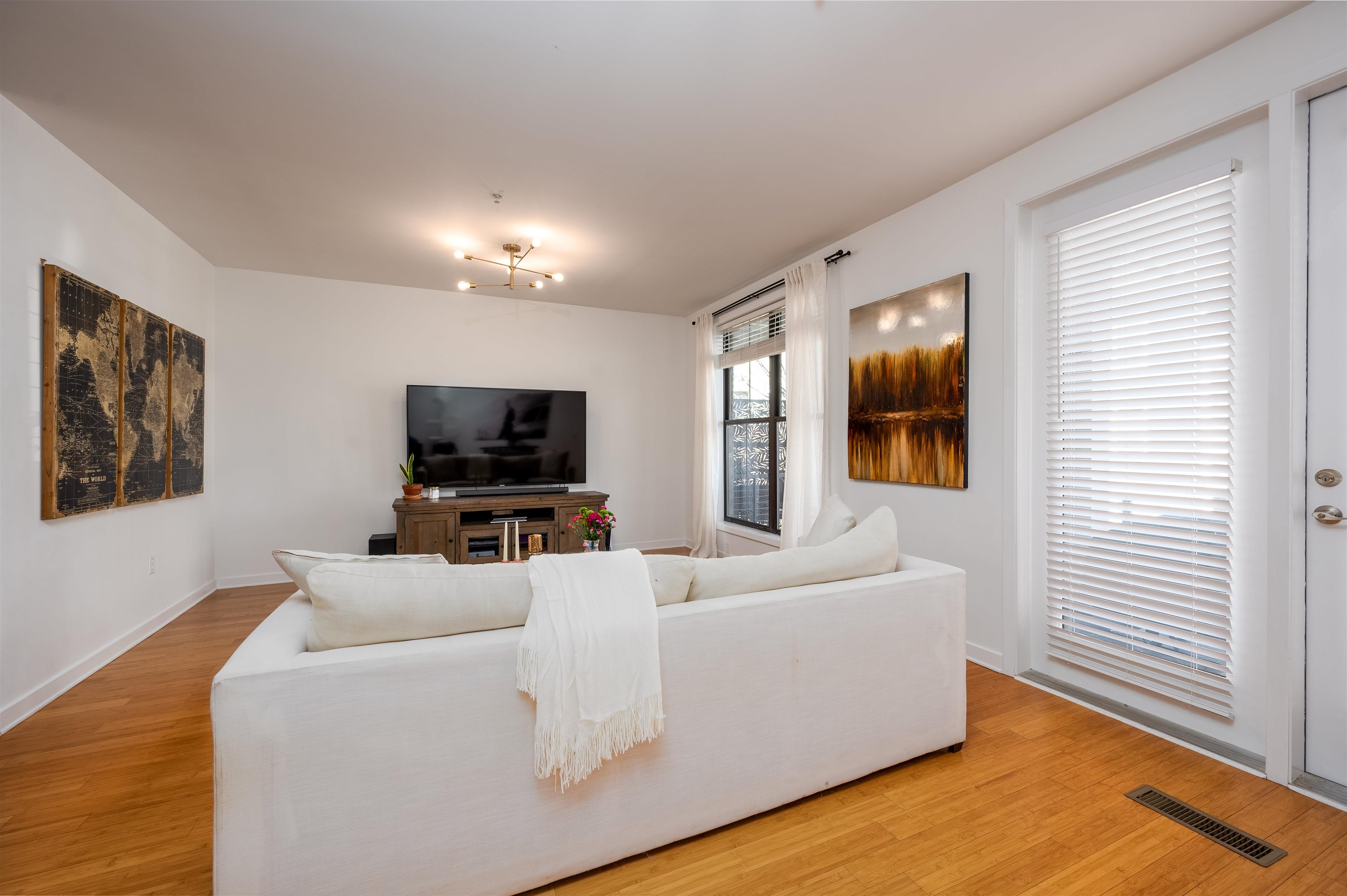 379 Cobalt Bay Loop, Unit 102 Memphis, TN 38103 - Photo 8 of 21 a living room with furniture and a flat screen tv
