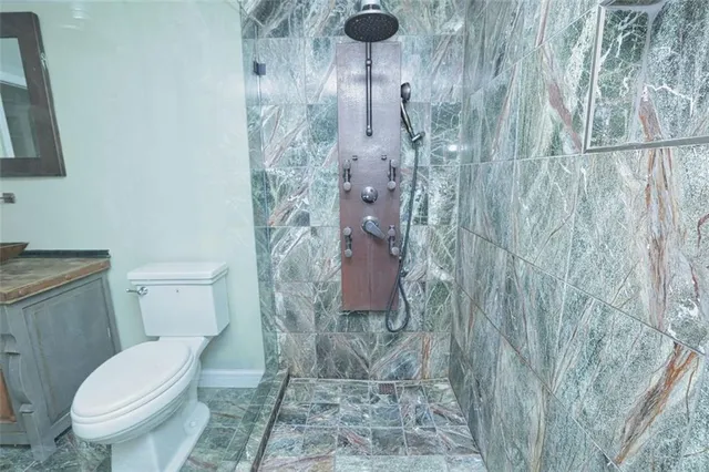 a white toilet sitting next to a shower curtain