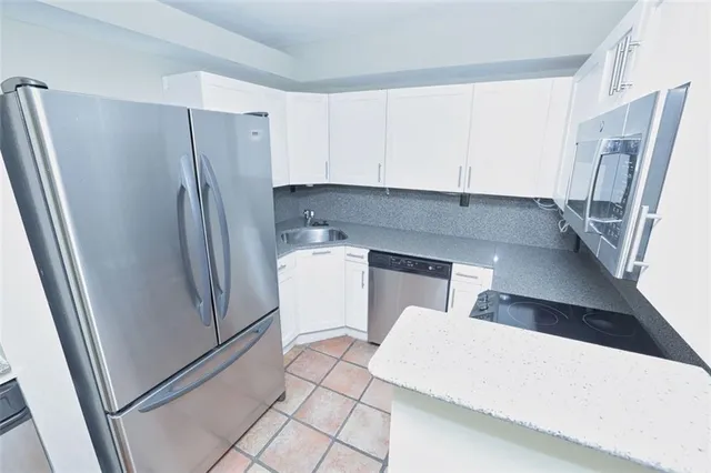 a kitchen with stainless steel appliances a refrigerator and a sink