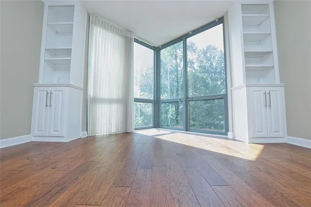 wooden floor in an empty room with a window